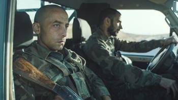 I Was a Stranger movie: Yahya Mahayni wears fatigues, riding in a car