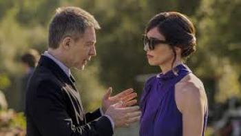 I Can't Live Without You: Man uses hands as he talks to a woman in purple