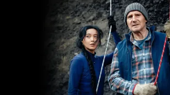 Ice Road: Vengeance movie: Liam Neeson in winter hat right holds onto carabiner and rope next to Chinese woman center holding onto her own rope