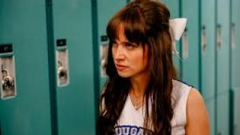 Identity Theft of a Cheerleader: Maiara Walsh in a cheerleading outfit stands near blue lockers.