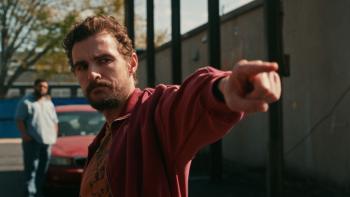 Idiots movie: Dave Franco looks stern and points, with O'Shea Jackson Jr. standing behind him by a red car