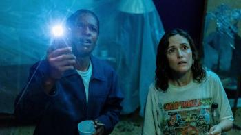 If I Had Legs I'd Kick You movie: A$AP Rocky aims a flashlight upward while he and Rose Byrne look shocked at what they see