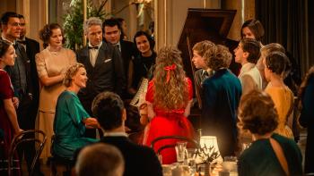 I'll Find You Movie: Connie Nielsen plays the piano at a gathering while lovingly looking at a boy who's singing