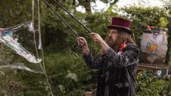 Bolan's Shoes: A bearded man creating a bubble