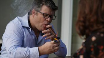 iMordecai Movie: Sean Astin smokes a cigar while sitting across from a woman