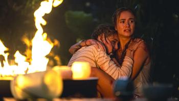 In Cold Light movie: Two women huddle together in front of flames