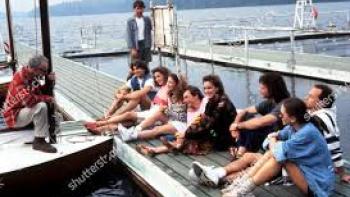 Indian Summer: Characters sit on a dock