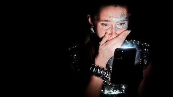 The Influencer Project Movie: In a silver, sparkly dress, her face painted, Chiara is shocked by something on her phone