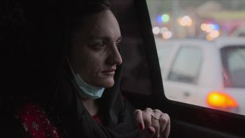 Zarifia Ghafari as a passenger inside a car.