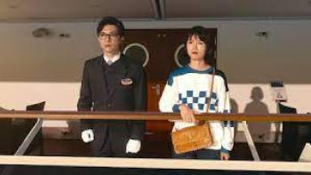 In Love and Deep Water: Asian man and woman stand om a ship's deck