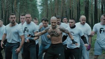 Inside Furioza movie: Many White Polish bald men in white sweatshirts get behind their shirtless leader center, as they prepare to face a rival gang