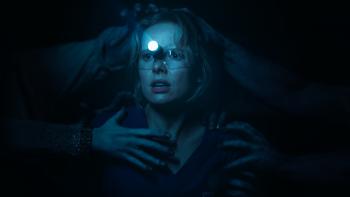 Insidious: Out of the Further Movie: Gemma, wearing dental goggles, is clutched at by several ghostly hands in the Further