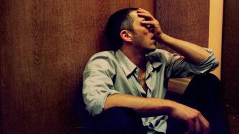 Irreversible: Vincent Cassel sits on the floor with his hand on his face
