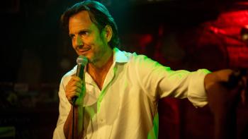 Is This Thing On? movie: Alex Novak (Will Arnett) is a stand-up comedian holding a microphone on stage
