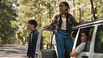 It Ends Movie: James, Day, and Fisher wait by their car with the door open, looking toward the woods