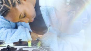 It’s Dorothy! movie: a Black woman in a blue jacket writes with a pen