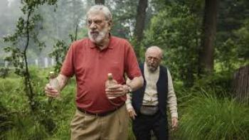 It Takes a Village: Two older men walk in the forest
