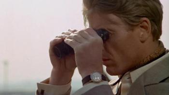 The Day of the Jackal: Edward Fox holds a pair of binoculars up to his face
