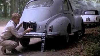 The Day of the Jackal: Edward Fox removes a license plate from a car parked by the side of the road