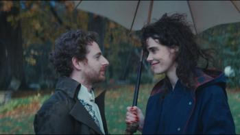 Jane Austen Wrecked My Life movie: Pablo Pauly and Camille Rutherford share a smile on a rainy day under an umbrella