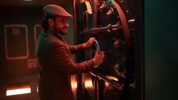 Jewel Thief: The Heist Begins movie: Indian bearded man in cap center grabs hold of wheel handle of large vault safe