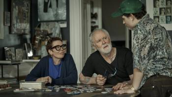 Jimpa: Olivia Colman and John Lithgow sit at a dining table looking up at Aud Mason-Hyde