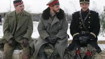 Joyeux Noel: Three soldiers sit, one with pipe