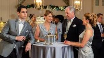 Joy for Christmas: Dressed-up couples stand around a table