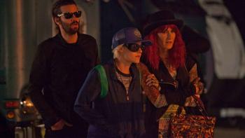 J.T. LeRoy Movie: Savannah, Laura, and Geoffrey wear sunglasses and cluster together in front of a building