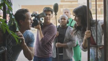 The Adventures of Jurassic Pet: Return to the Wild: a film crew huddle in a doorway with surprised looks on their faces. 