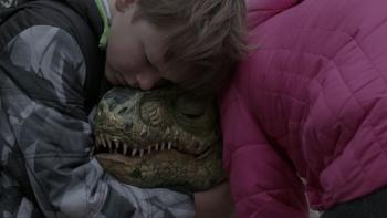 Kids hugging baby dinosaur