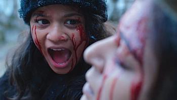 The Kashmir Files: A child screams near her dead mother; both faces are covered in blood.