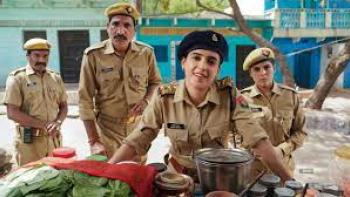 Kathal - A Jackfruit Mystery: a female soldier stands with male soldiers