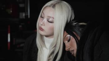 Katseye—Wild Hearts: KATSEYE members Lara Rajagopalan and Jeong Yoon-chae rest their heads together as they both look exhausted