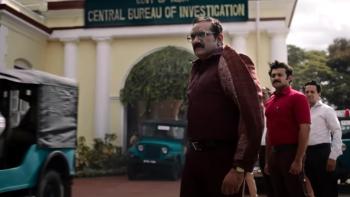 K.G.F. -- Chapter 2: Three Indian men look on as they stand outside the Central Bureau of Investigation