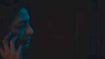 Khufiya: An Indian woman talks on the phone in darkness.