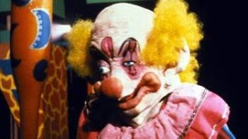 Killer Klowns from Outer Space: Creepy clown with yellow hair and a pink outfit against a dark backdrop.