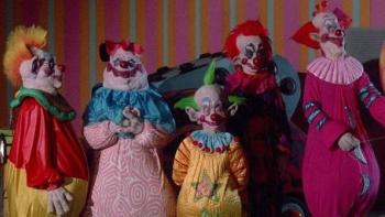 Killer Klowns from Outer Space: Colorful clowns in a striped room, displaying varied expressions.