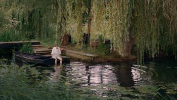 Kindling: George Somner sits on a wooder boat dock looking out over a lake.