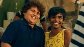 Kings of Mulberry Street: Let Love Reign: An Indian South African boy in dark blue shirt left laughs with and next to an Indian South African boy in no-sleeved yellow shirt on right