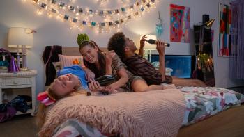 Kissing Is the Easy Part movie: Three teen friends (Hayley Festeryga, Paris Berelc, Roshahn Dhoré) laugh while lying  on a bed
