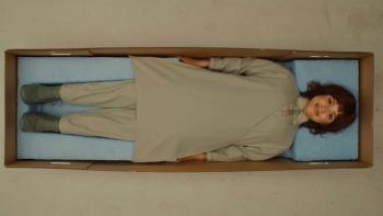 Klara and the Sun Movie: Klara lies on her back in a cardboard box, smiling