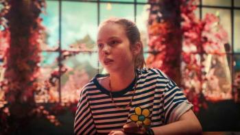 Kleks Academy: A girl sits by a window.