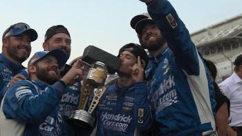 Kyle Larson vs. The Double movie: Kyle Larson kisses the Brickyard 400 trophy while celebrating with his NASCAR team