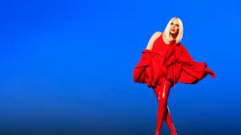 Kylie Tension Tour Live Movie: Kylie in red outfit against a vibrant blue background.