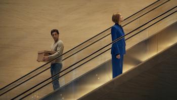 Ladies First: Sacha Baron Cohen and Rosamund Pike on an escalator.