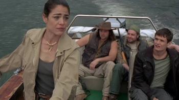 Lake Placid 3: Woman steering a boat with three men seated behind her.