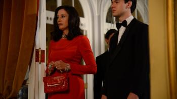 Lamborghini: The Man Behind The Legend: A smartly dressed middle-aged woman with brown hair looks upset while stood next to her teenage son