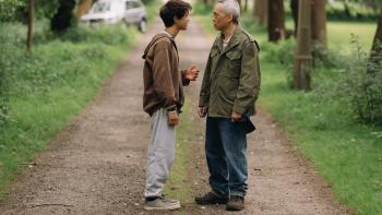 Last Days movie: Sky Yang stands in road facing Ken Leung