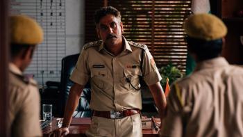 Last Days movie: Naveen Andrews leans against a desk talking to two police officers